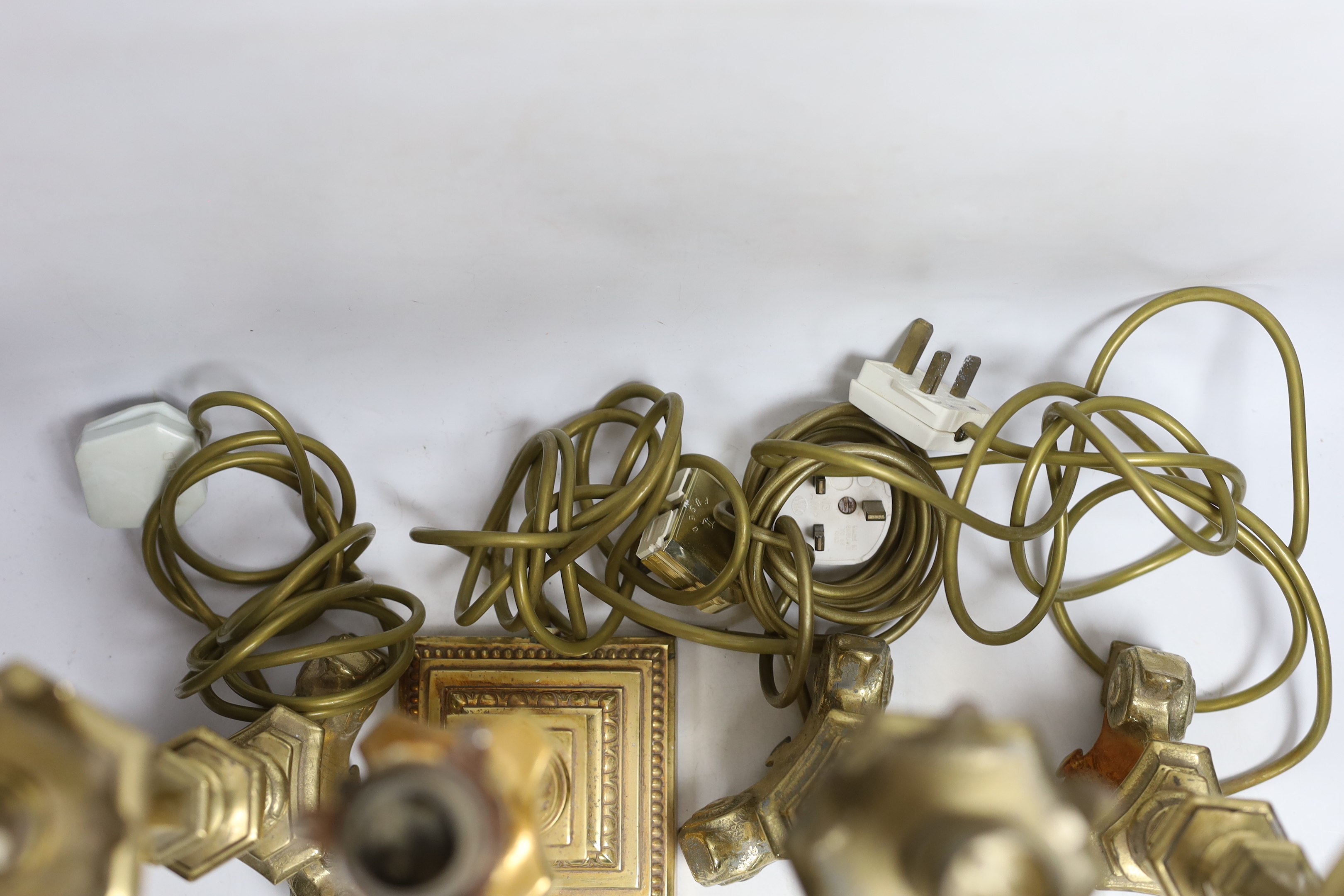Four brass column lamps including a set of three, largest each 44cm high